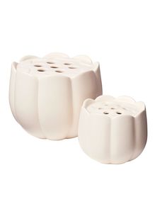 two white toothbrush holders sitting next to each other