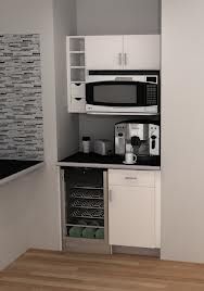 a small kitchen with white cabinets and black counter tops