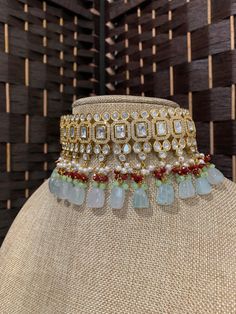 Crown style tyaani kundan choker karan. Micro gold plated , AD work . Foil kundan mounted on the brass made frame. Glass and crystal drops. Mint quartz beads at the end. thus masterpieces item comes with matching earring and Tikka. Neck is about 2 inch wide with drops . Earrings are 2.5 inch and full side Tikka . Chandbali Kundan Necklace Jeweled, Kundan Necklace With Stone Work For Reception, Diwali Kundan Jeweled Necklace, Festive Bollywood Kundan Necklace With Jewels, Jeweled Kundan Necklace For Party, Bollywood Style Kundan Festive Necklace, Gold Kundan Choker Necklace, Gold Kundan Choker With Gota Work, Party Kundan Choker With Cutdana