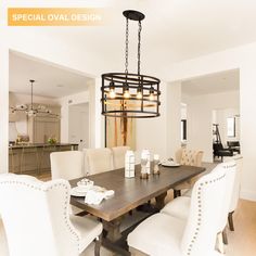 a dining room table with white chairs and a chandelier