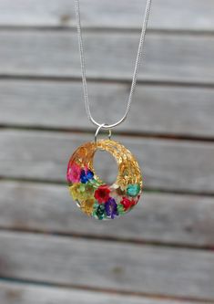 a multicolored necklace hanging from a chain