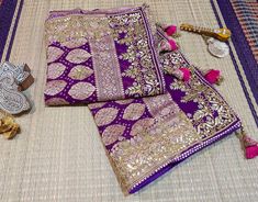 A Lovely Purple Pink Banarasi Georgette Bandhani Gota Patti Saree in Gharchola Pattern. The saree is adorned with intricate gota patti handwork which makes it all the more a perfect choice for occasion wear. Its a fusion of karigari from Banaras, Gujarat and Rajasthan. We must say, a truely heirloom piece. The zari work on the saree is done in Banaras and then the Bandhej is tye and dyed in Gujarat. Then the karigars of Rajasthan have worked their magic with the gota embroidery. So its takes abo Purple Traditional Wear With Dori Work, Traditional Purple Wear With Dori Work, Traditional Katan Silk Wear With Dori Work For Festivals, Festival Katan Silk Traditional Wear With Dori Work, Festival Traditional Katan Silk Attire With Dori Work, Purple Traditional Drape With Gota Work, Traditional Purple Dupatta With Dori Work, Purple Saree With Gota Work In Traditional Drape, Purple Traditional Wear With Dori Work For Festivals