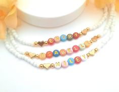 Child Name Necklace Color beads necklace gift for toddler girl jewelry for birthday Christmas gift letter bead necklace Kids name necklace This darling name necklace is so sweet, colorful and surely will make a perfect birthday gift, Christmas gift or and every day favorite accessory  100% made to order and handcrafted with excellence and precision into a beautiful, personalized name necklace that is so special and perfect for gift giving. Arrives in a white gift box with a bow ready for gifting. The colorful beads are carefully chosen to form a random color design for a personalized style. We use strong stretch cord to string the beads on. Because this necklace is a stretchy it does not require a clasp which makes this beautiful, dainty, personalized name necklace easy to put on and easy Color Beads Necklace, Gift Letter, Toddler Girl Gifts, Letter Gifts, Color Beads, Girl Jewelry, Letter Beads, White Gift Boxes, Girls Necklaces