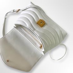 New wave design Hold me Bag from the new family of wave. Color: White. Ref: M21797. Smooth cowhide leather. Smooth cowhide leather trim. Microfiber-lining. Gold finished hardware. An elegant new flap closure. “LV” metal logo on the front. Adjustable and removable leather shoulder strap.(Drops Min: 50 cm/Drops Max: 53cm) Hand carry single top handle. 2 ... New Wave Design, Me Bag, New Family, Wave Design, Metal Logo, Hold Me, Pocket Size, Metallic Logo, New Wave