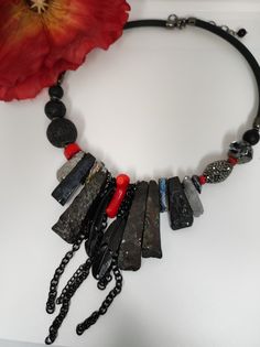 I made this necklace in a modern style with an ethnic touch. To create this necklace I used different types of stones and crystals. The necklace is made of large irregular flakes of agate and bone stone galvanized in black and silver, colored quartz, coral slats, lava stone and glass and resin beads. The central part of the necklace is made with rather large stones which make it very eye-catching. The main color is black with a touch of red given by the coral sprigs. This necklace is the fruit of my imagination, it is an artistic jewel created with various natural stones and crystals. The necklace is rigid but rests naturally on the neck, very comfortable to wear. The back is made with silicone cord. The necklace is very bright, 48cm long with an adjustable lobster clasp. It is a particula Unique Natural Stone Necklaces For Parties, Bohemian Beaded Necklaces With Natural Stones For Party, Bohemian Natural Stone Crystal Necklaces For Parties, Bohemian Crystal Necklaces With Natural Stones For Party, Unique Stone Necklaces For Party, Unique Gemstone Beads Necklace For Party, Unique Necklaces With Stones For Party, Party Necklaces With Gemstone Beads, Unique Party Gemstone Beads Necklaces