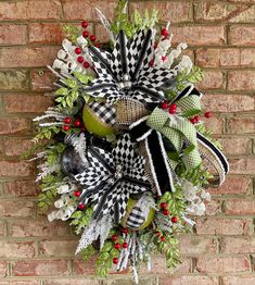 a christmas wreath hanging on a brick wall