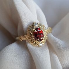 Read about our payment plans before proceeding. In the heart of this exquisite Faith ring, a crimson spinel nestles, a gem of nature's tender artistry. Embraced by delicate scroll-like motifs, each curve whispers tales of timeless elegance, bestowing upon it a vintage flair that dances with the echoes of ages past. Crafted by skilled hands, this ring is available in your choice of 14K and 18K yellow gold, rose gold, and white gold. All orders come in our Tippy Taste ring box. This ring is handmade and designed in NYC. 14K or 18K solid gold Natural red spinel, 6*4mm Natural round diamonds. SI clarity, GH color, 0.02ct total carat weight 1.5mm ring band ** Tippy Taste Heirloom Collection is made to order. Please allow 3-4 week turnaround time. Shipping:Domestic: Free shippingInternational: F Red And Gold Wedding Rings, Vintage Garnet Engagement Ring, Ruby And Pearl Engagement Ring, Red And Gold Engagement Ring, Red Engagement Rings, Nontraditional Engagement Rings Vintage, Red Ring Aesthetic, Engagement Rings Red, Tudor Ring