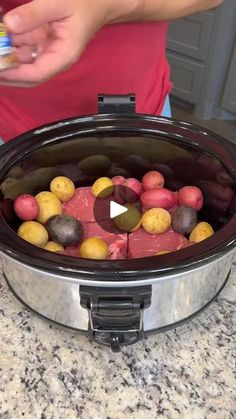 a slow cooker filled with potatoes and meat