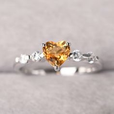 ◆ The ring is handcrafted from sterling silver and decorated with a dazzling 6*6 mm natural Citrine and tiny CZs. It is suitable for engagement/anniversary/daily occasion. ◆ Production Description: Main stone Type: Natural Citrine Main Stone Shape: Heart cut Main Stone Size: 6*6 mm(0.76ct) Side stone: CZ Metal: 925 Sterling silver - Other options available in the drop down menu ◆ Customization: √Free for Add Engraving √Other Metal Type Available √Other Gemstones & Shapes Available √Personali Heart Cut Topaz Gemstone Ring For Promise, Heart Cut Topaz Ring For Promise, Heart Cut Topaz Promise Ring, Promise Ring With Citrine Birthstone, Citrine Birthstone Ring With Gemstone For Promise, Citrine Gemstone Birthstone Ring For Promise, Heart Cut Topaz Jewelry For Anniversary, White Topaz Ring As A Gift, Gift White Topaz Ring