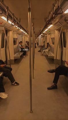 people are sitting on the subway cars with their feet up