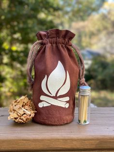 "What you receive: 5\"x7\" brown cotton carrying pouch With choice of  8 one inch soy fire starters OR bag of kindling  Mini jar with striker bottom & 12 matches If you're looking to make fire starting easier, while adding a stylish accessory to your campsite or cookout, look no further! These all natural fire starters come in a reusable hand dyed cotton pouch, and are made using wood shavings and recycled soy wax. Each fire starter will burn around 20 minutes in both rain and wind. Proven and tested while camping in the damp and humid mountains of North Georgia, these fire starters are a great beginning to time spent around the campfire, wood-burning stove, fireplaces, or grill!  Please practice fire safety and follow local guidelines.  Find matching fire starting pouch and spice kit here Cook Out, Bush Craft, Wood Shavings, Mini Jars, Fire Starter, Cotton Pouch, Camping Items, Camping Games, Boy Scout