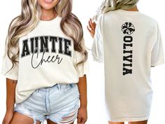 Show your spirit on game day with our custom Cheerleader Aunt shirt, featuring a varsity style "cheer auntie" design personalized with the cheerleaders name on back. This cute and stylish shirt makes the perfect gift for any cheer auntie passionate about cheerleading. COMFORT COLORS 1717 SHIRT: Unisex 100% US cotton - ethically grown and harvested Pre-Shrunk Fabric Relaxed Fit - Size up for a trendy oversized look Seamless Sides Double Needle Stitching Garment-dyed  CARE INSTRUCTIONS: Wash insid Customizable Casual T-shirt For Cheerleading, Varsity T-shirt With Custom Print For Game Day, Cheer Aunt Shirt Ideas, School Spirit Tops With Custom Print For Fan Gear, Custom Print School Spirit Tops For Fan Gear, School Spirit Fan Gear Tops With Custom Print, Custom Print Tops For School Spirit Fan Gear, Collegiate T-shirt For Cheerleading With Team Name, Customizable Varsity Tops For Game Day