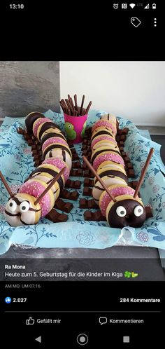 a cake made to look like caterpillars with eyes and legs on top