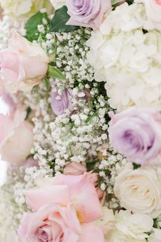 a bunch of flowers that are in the middle of some kind of flower arrangement on a table