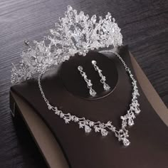 a tiara and earrings on display on a table