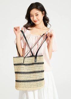 Make a statement with our Woven Striped Tote with Leather Handles, perfect for an effortlessly stylish look. With its durable cellulose material and trendy color-blocking design, this tote boasts a chic vertical square shape and features a practical internal phone pocket. The soft texture and striped pattern add a touch of sophistication, while the leather handles ensure comfortable carrying, making it an ideal accessory for your daily endeavors or leisure activities. Take this versatile tote to Versatile Rectangular Straw Bag For Daily Use, Trendy Square Bucket Bag, Square Bucket Bag With Adjustable Strap For Shopping, Trendy Rectangular Bucket Bag For Shopping, Trendy Square Bucket Bag For Vacation, Modern Rectangular Straw Bag For Daily Use, Versatile Square Bucket Bag For Shopping, Square Bucket Bag For Vacation, Casual Rectangular Bucket Bag For Shopping