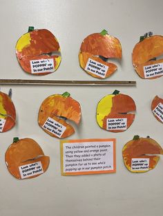 a bulletin board with cut out pieces of pumpkins and words written on the boards