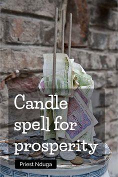 a candle is sitting on top of a pile of money with the words candle spell for prosperity