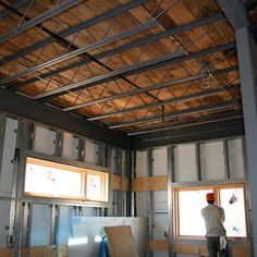 a man standing inside of a building under construction