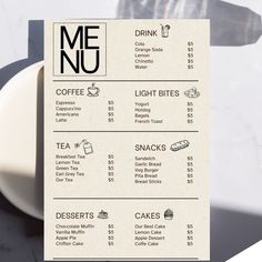 the menu for meu coffee is displayed on a white plate next to a cup and saucer