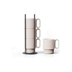 two cups and a mug stand next to each other