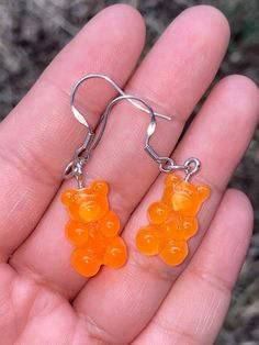 "Orange, TEDDY, GUMMY, bear ,earrings. Light in weight. Fun dangle drop earrings.  Style: Hipster, Kitsch, goth, grunge, punk, hipster, Kawaii, Boho, Hippie, Retro. Made out of plastic.  For pierced ears. approximate measurements: body of earrings: 5/8\" L x 3/8\"W drop of earrings: 1 5/8\" L" Dangly Gummy Bear Earrings Betsey Johnson, Goth Purse, Grunge Earrings, Gummy Bear Earrings, Woodland Earrings, Hippie Purse, Red Heart Earrings, Bear Earrings, Kawaii Earrings