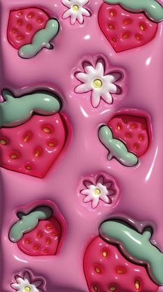 some pink and green strawberry shaped chocolates with flowers