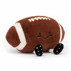 a brown stuffed toy with a football on it's back and white dots around the eyes