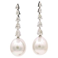 South Sea pearl drop earrings featuring 10 pear shape diamonds weighing 1.40 carats, in 18k white gold. South Sea Pearls: 12-13 mm Color: G-H Clarity: SI Sea Pearl, Diamond Drop Earrings, South Seas, South Sea Pearls, Sea Pearls, Diamond Drops, Pear Shaped Diamond, Pearl Drop Earrings, Pearl Drop