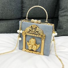 Introducing our exquisite Baroque Frame Flower and Angel Handbag, a stunning accessory that embodies elegance and charm. Free shipping in the US and worldwide. Length: 18 cm (7.09 inches); Height: 17 cm (6.69 inches); Width: 8 cm (3.15 inches). Crafted from high-quality PU leather, this handbag boasts both durability and style. The intricate baroque frame adorned with flowers or angels adds a touch of sophistication to any ensemble, while the square design provides ample space for your essentials. The unique baroque frame design sets this handbag apart, making it a standout accessory for those who appreciate fine craftsmanship and attention to detail. Available in black, pink, white, and gray colors, this handbag offers versatility to match a variety of outfits and aesthetics, including Co Golden Angel, Lv Bags, Victorian Vintage, Burberry Handbags, Cute Purses, Prada Handbags, Vintage Elegant, Glamour Fashion, Mini Crossbody Bag