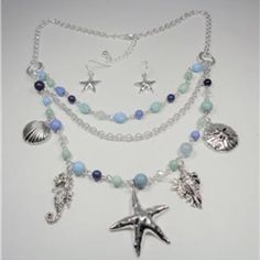 This Beautiful Rhodium Nautical Starfish Seashell Aqua And Blue Beads Sea Life Layered Necklace And Earrings Set Features Aqua, Blue And Rhodium Beads With The Rhodium Sea Horse, Seashells, Sand Dollar And Starfish Charms As Well As Aqua And Blue Beads And Bluish Pearls. The Silver Tone Necklace Is 20 Inches Long With A 2 Inch Extender To 22 Inches And Has A Lobster Claw Clasp For A Secure Fit On Your Neck. The Starfish Pendant Measures 1 1/2 Inches High And 1 1/2 Inches Wide. Cn 5-0032 Blue Beads Necklace, Sea Life Necklace, Sea Accessories, Rhodium Jewelry, Pearl Cluster Necklace, Shell Choker, Starfish Pendant, Starfish Necklace, Premier Designs Jewelry