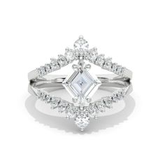 a white gold ring with an emerald cut diamond in the center, surrounded by diamonds