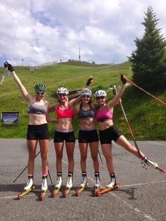 three women on roller blades are posing for the camera with their arms in the air