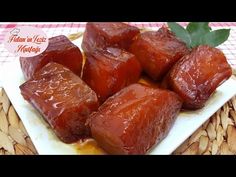 some food is on a white plate and sits on a tablecloth with a red checkered table cloth