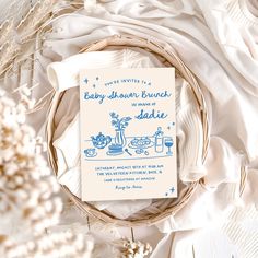 a baby shower brunch is shown on a white background with flowers and feathers