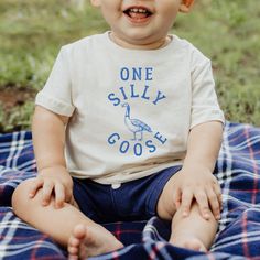 This One Silly Goose fine jersey baby tee is the perfect shirt for your Silly Goose 1st birthday party! These 100% Cotton tees are soft, comfortable and will be the cutest party shirt for your 1 year old. -100% Cotton -True To Size -Comes in TSHIRT sizes 6M-24M CARE .Turn inside out to wash, with like colors on cold delicate cycle .Non-chlorine bleach to wash .Tumble on low to dry or hang .No ironing or dry cleaning ORDER PROCESSING Each tee is made to order and printed as each order is placed. One Silly Goose Birthday Party Boy, Short Sleeve Tops With Name Print For Playtime, Cute Short Sleeve Shirt For First Birthday, Summer Cotton Tops With Number Print, White Cotton Top For First Birthday, First Birthday Graphic Tee With Crew Neck, Playful Crew Neck Top For First Birthday, First Birthday Graphic Tee With Name Print, Fun Short Sleeve Tops For First Birthday