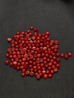 a pile of red candies sitting on top of a table