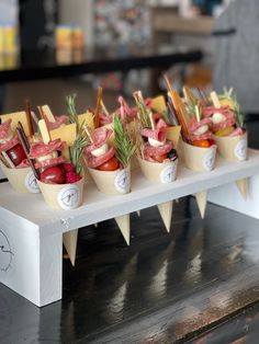 small cups filled with different types of food