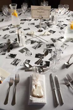 the table is set with silverware and photos for guests to take pictures on it