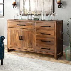 a wooden cabinet with glassware on top and a blue chair in the foreground