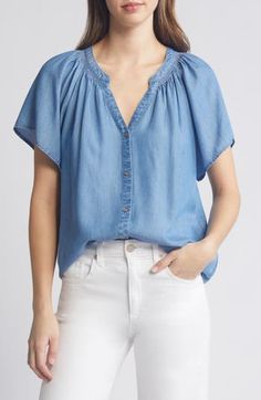 Soft gathers lend graceful movement to this soft chambray shirt framed by fluttering sleeves. 25 1/2" length Front button closure Split neck Short sleeves 100% lyocell Machine wash, tumble dry Imported Summer Denim Button-up Blouse, Casual Flutter Sleeve Blouse For Fall, Blue Tencel Denim Top For Summer, Chic Short Sleeve Relaxed Fit Denim Top, Chic Short Sleeve Denim Blouse, Chic Relaxed Fit Short Sleeve Denim Top, Casual Flutter Sleeve Blouse For Spring, Casual Spring Blouse With Flutter Sleeves, Relaxed Fit Denim Blouse For Day Out