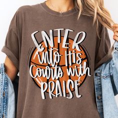 a woman wearing a t - shirt that says enter into his courts with praise