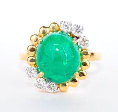 "A fabulous emerald diamond ring handcrafted in solid 18kt yellow gold. The ring is studded with a top quality green and brilliant natural Colombian emerald which measures 10mmX13mm in size, stands 7mm tall and weighs 7.23 carats. The diamonds weigh 0.43 carats and grade at VSI2 clarity and H-I color. The ring is of SIZE US 7.5 and can be resized. It was handmade in 18kt gold and weighs 6.30 grams. It is duly stamped on the underside of the shank for all the contents and gold purity, so no guess Green Cabochon Emerald Ring Fine Jewelry, Fine Jewelry Green Emerald Cabochon Ring, Fine Jewelry Green Cabochon Emerald Ring, Fine Jewelry Emerald Diamond Cabochon Ring, Exquisite Green Diamond Ring With Vvs Clarity, Emerald Cabochon Ring With Diamond, Perfect As Gift, Emerald Cabochon Ring With Diamond - Gift, Emerald Cabochon Ring With Diamonds As A Gift, Exquisite Green Diamond Ring With Prong Setting