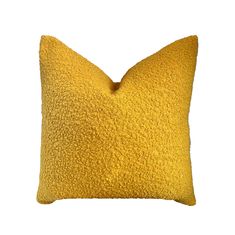 a yellow pillow on a white background with no one in the photo to describe it