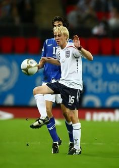 two men are playing soccer on the field