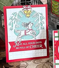 two christmas cards, one with a reindeer on it and the other with an ornament