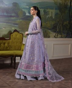 Fiore’ Timeless charm meets modern flair in this lilac paneled flare shirt. Delicate pink and lilac hues dance across the soft lilac base, adorned with intricate silver embroidery and hand-embellished details. A pop of aqua at the hem adds a fresh twist, while the organza dupatta’s hot pink borders and floral motifs complete the look. With its captivating blend of elegance and modern panache, this ensemble is a harmonious balance of classic charm and contemporary chic.Front Left Panel1 Embellish Lavender Organza Wedding Set, Lavender Wedding Set With Sheer Dupatta, Lavender Wedding Dress With Sheer Dupatta, Festive Lavender Long Sleeve Set, Formal Purple Sets With Intricate Embroidery, Elegant Lavender Sets With Sheer Dupatta, Fitted Lavender Sets With Sheer Dupatta, Fitted Lavender Long Sleeve Sets, Lavender Sets For Eid Reception