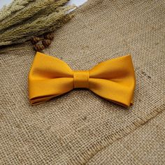 "We proudly present our solid marigold tie collection. -Hand-sewn semi skinny Adult Neck Tie -Pre-tied Bow tie available from Newborn up-to Adult size with adjustable strap. (Bow tie stitched into place) -Pocket square. Material: 100% Wool interlining Measurements: The necktie is 54\" or 137cm in length The widest part measures 2 3/4\" or 7 cm Pocket square measure approximately 10\" squares. Our experienced team has over 100 years worth of professional sewing experience combined. Our items are Gold Bow Tie For Formal Occasions, Dapper Gold Bow Tie For Formal Occasions, Gold Dapper Bow Tie For Formal Occasions, Elegant Yellow Bow Tie For Black Tie Events, Classic Gold Bow For Black Tie Events, Gold Dapper Ties For Weddings, Gold Bow Ties For Black Tie Events, Gold Bow Tie With Detachable Bow For Formal Events, Classic Gold Bow Tie For Groom