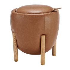 a brown leather stool with wooden legs and an oval shaped foot rest on the side