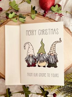 an open christmas card with two gnomes on it